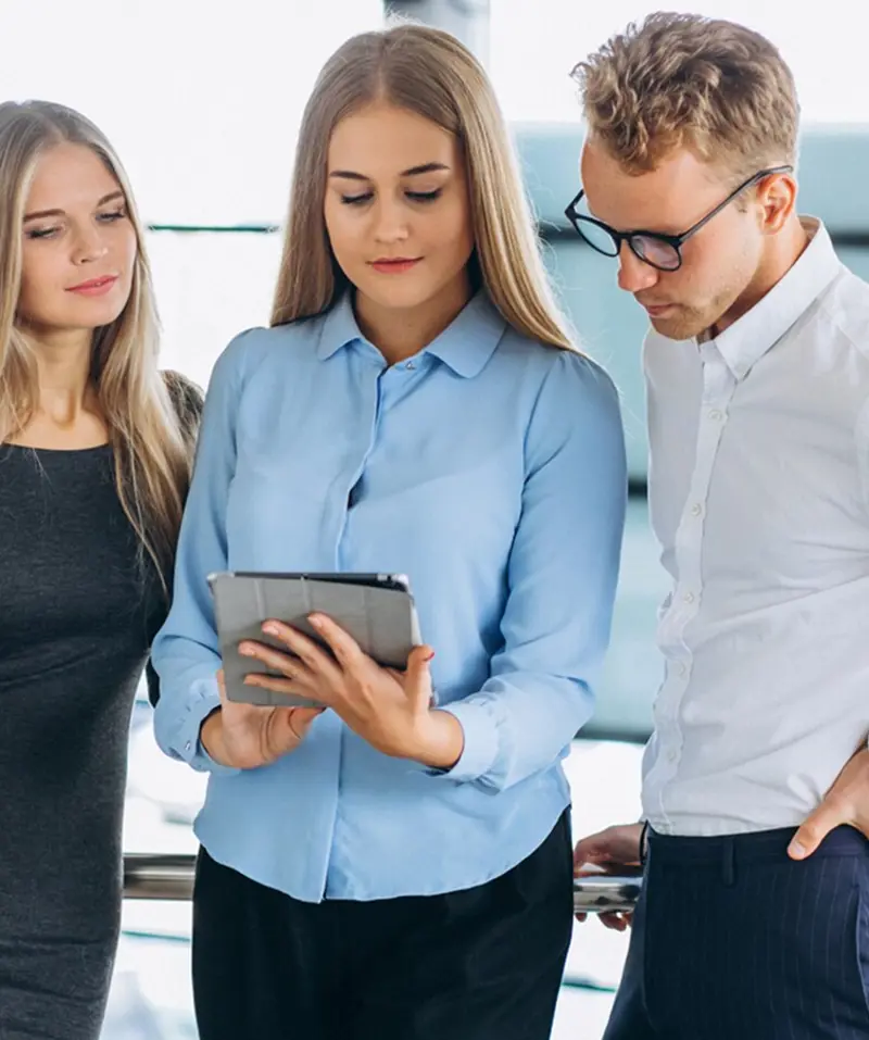 two-woman-and-one-man-looking-at-tablet