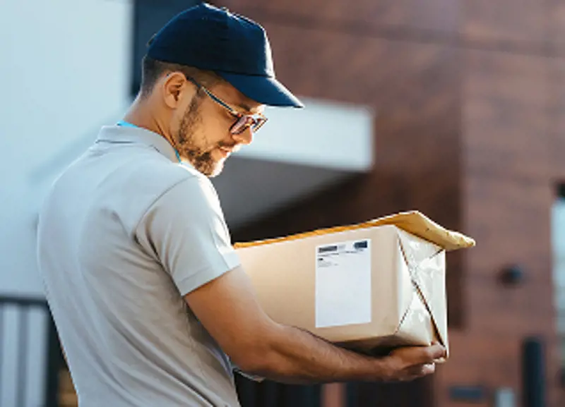 young-delivery-man-carrying-package-reading-address-label-his-customer-is-standing-background-4